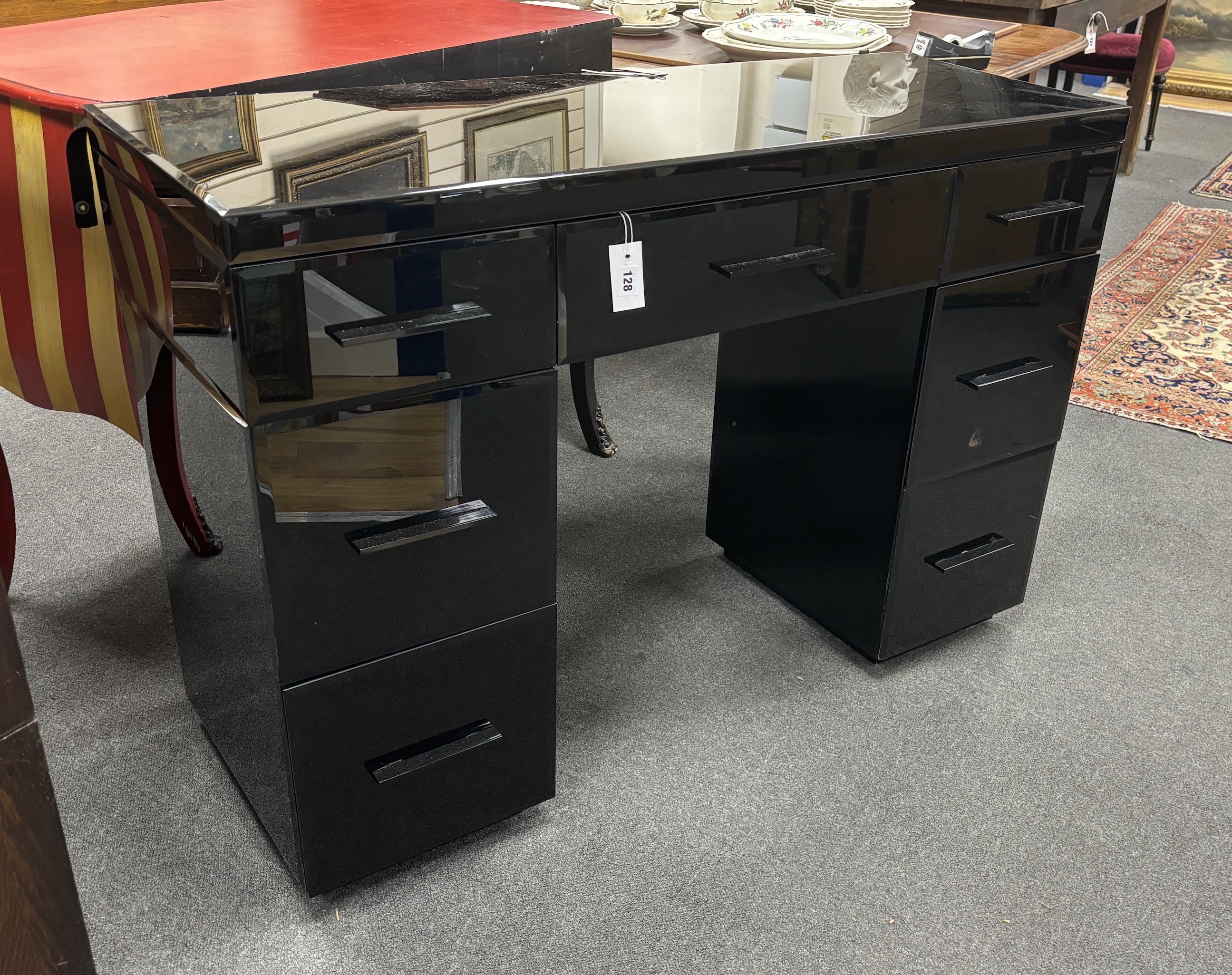 A contemporary black glass kneehole desk, width 121cm, depth 45cm, height 83cm